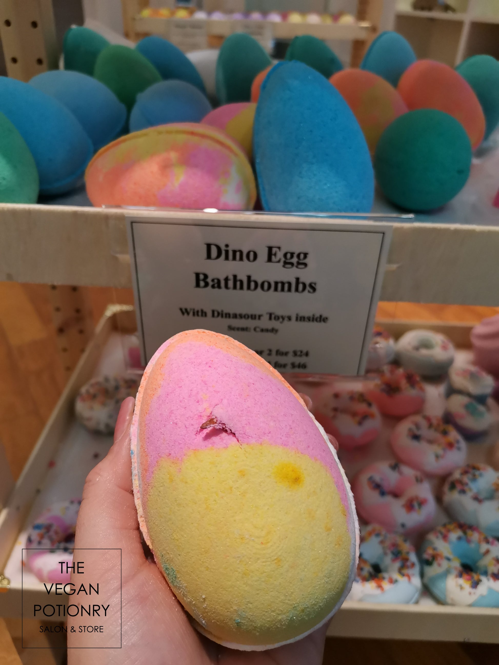 Pink and Yellow Dino egg bath bombs with dinosaur toys inside