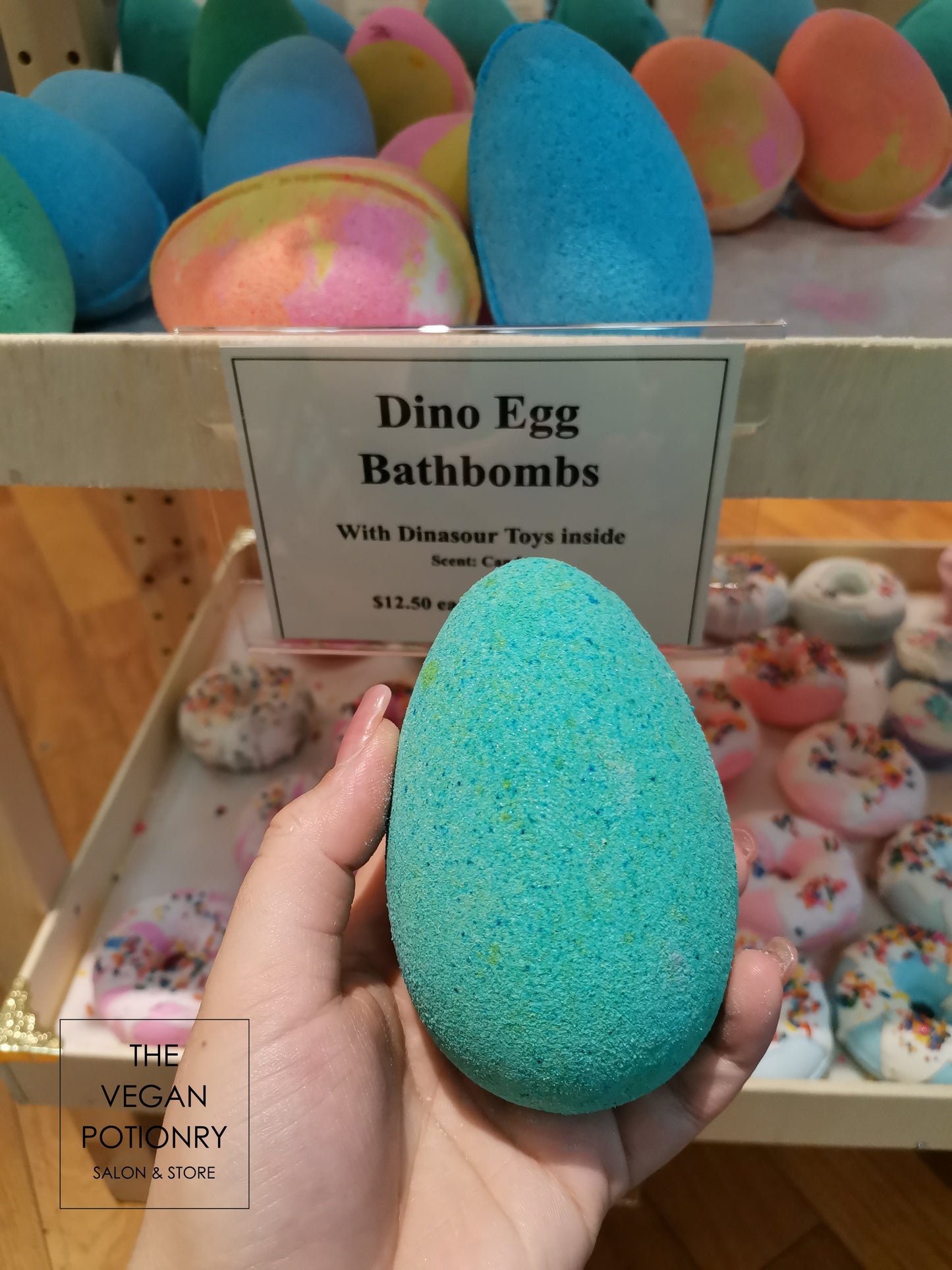 Teal Dino egg bath bombs with dinosaur toys inside
